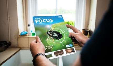 Somebody holding a magazine (Arable Focus, Winter 2025 edition).